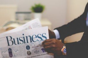 Man in Suit Reading Newspaper