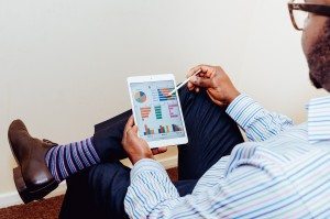 A man holding a tablet, dressed for success